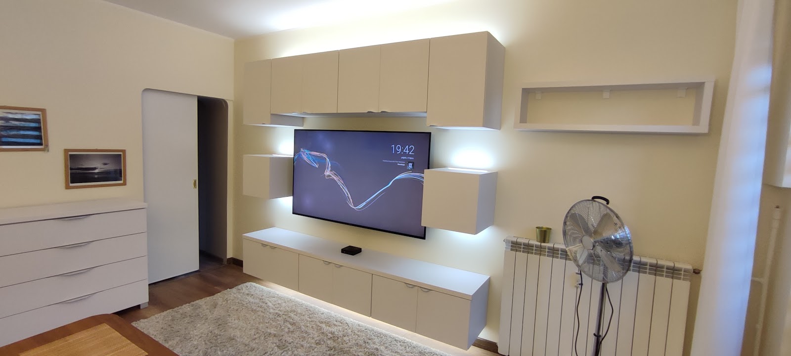 Nowoczesna meblościanka z podświetleniem LED pod telewizor — zabudowa salonu na wymiar